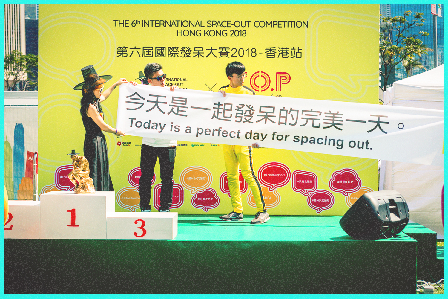 Attendants unfurl a banner on the stage of a Space Out Competition in Hong Kong. It reads: "Today is a perfect day for spacing out."