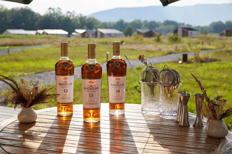 Three bottles of The Macallan on a table outside at Wildflower Farms in Hudson Valley. The Scotch brand is now offering luxury relaxation trips upstate.