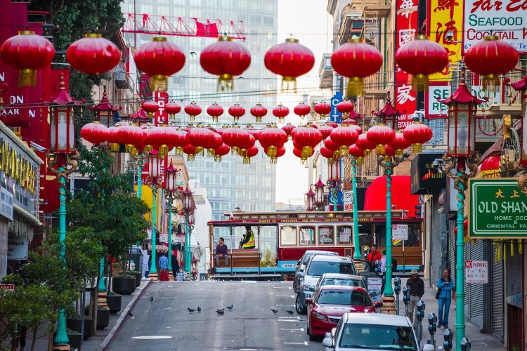 A cable car goes by in San Francisco's Chinatown.