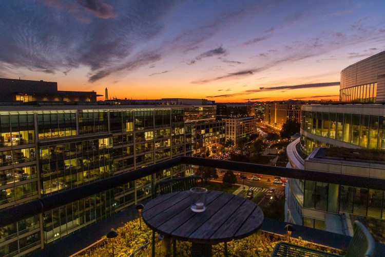 skyline at sunset, round table on terrace