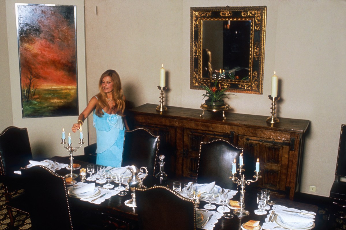 Egyptian-born singer Dalida lights the candles on her dinner table