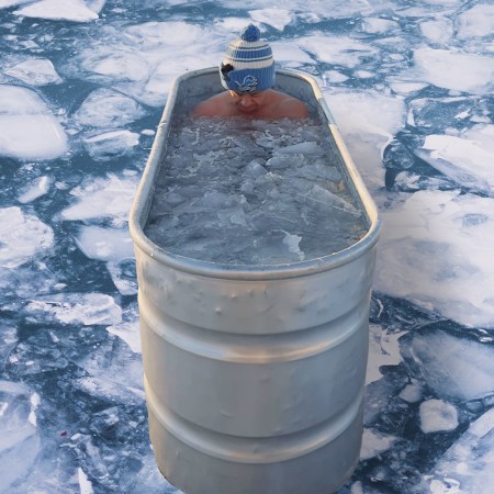 Jordan Ferrone sitting in a freezing ice bath. He's done a cold plunge every day for over 365 days.