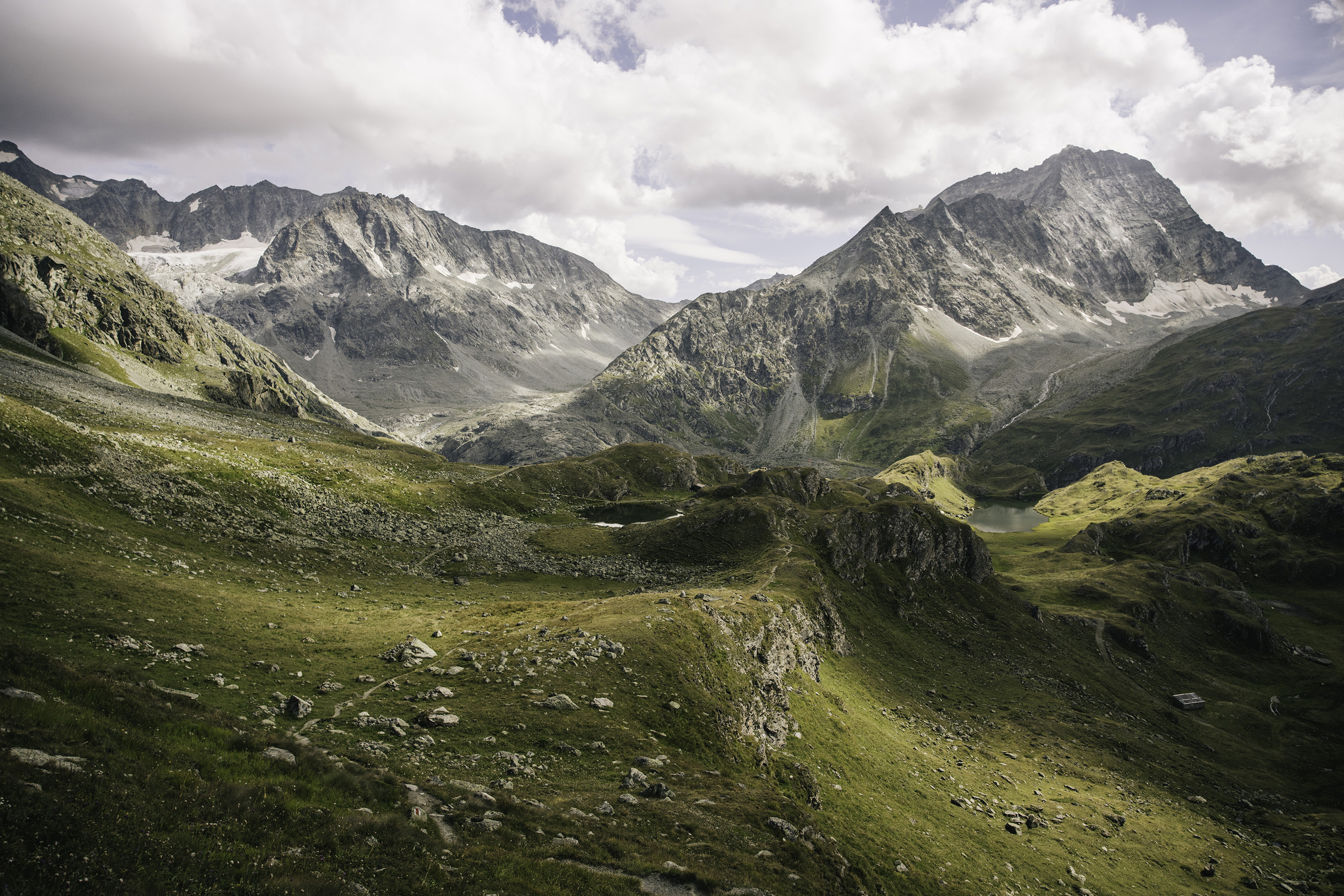 A panoramic view of a running trail in the Swiss Alps.