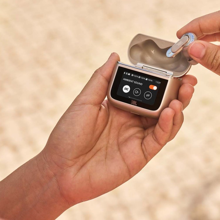 JBL Tour Pro 3 earbuds, held in a hand with a focus on the smart charging case