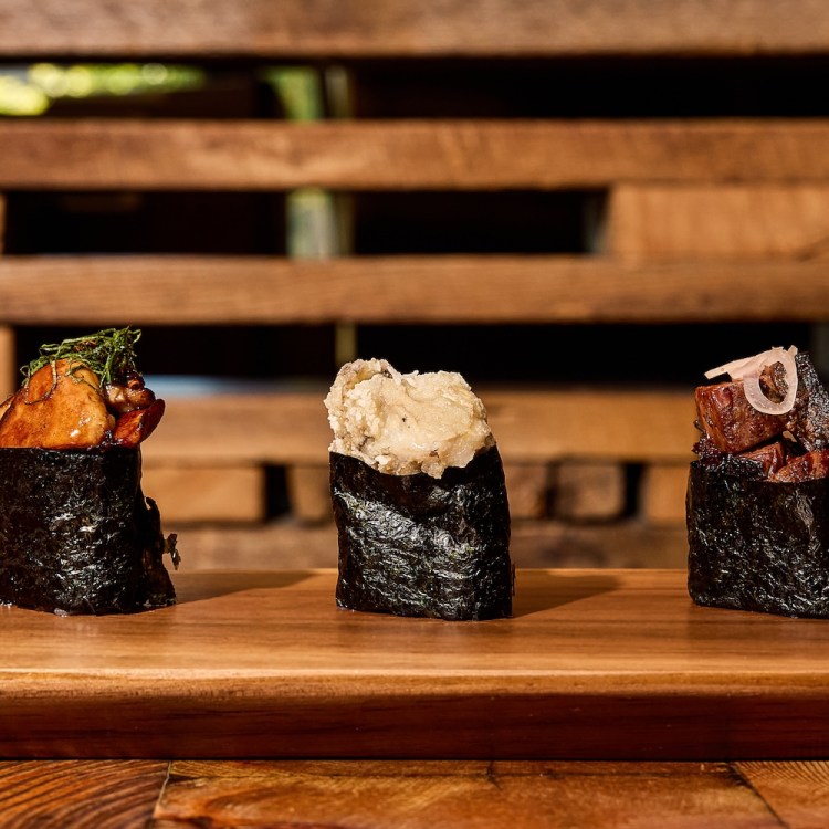 Three sushi rolls from Uchi plated and served next to each other