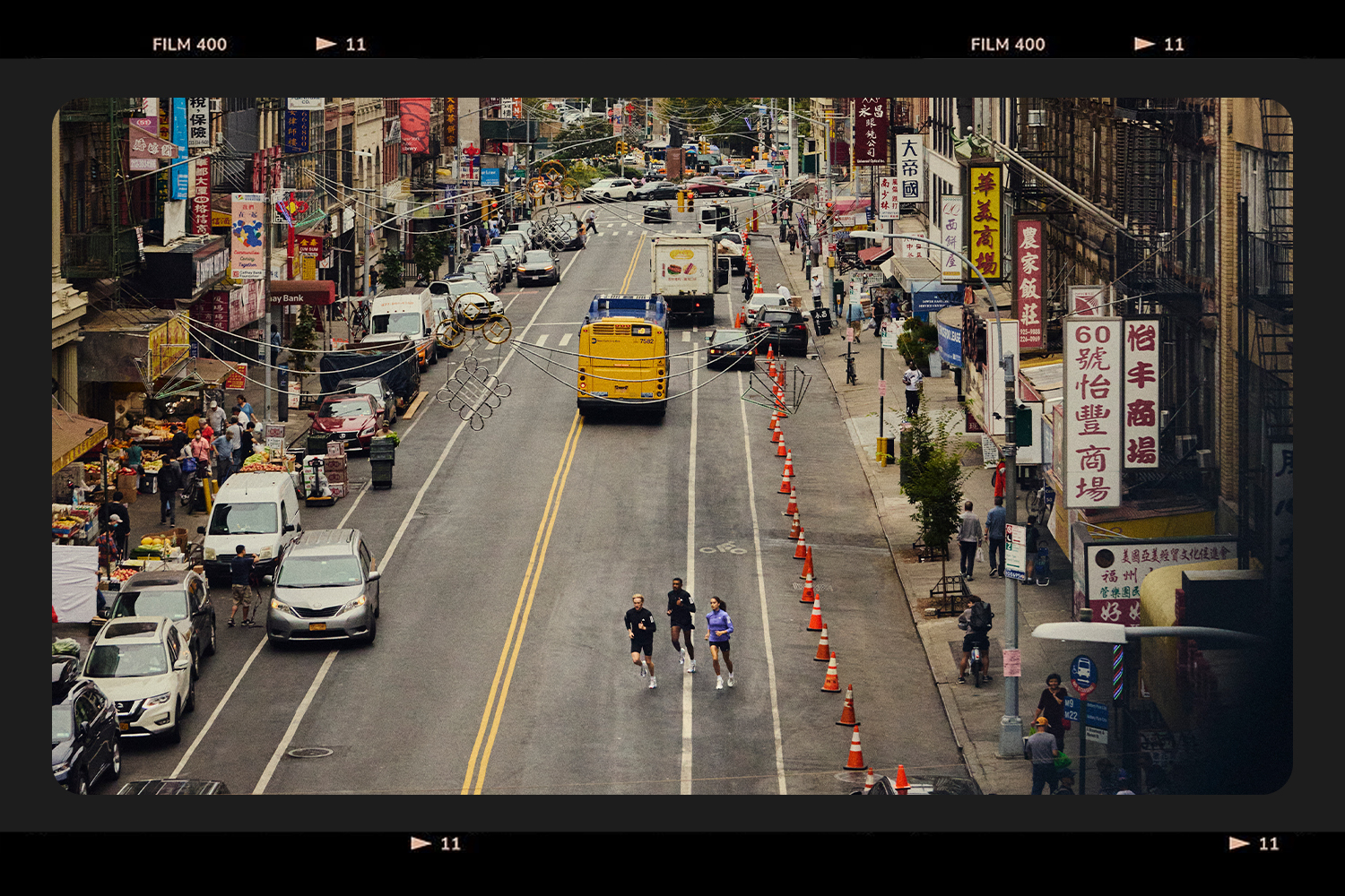 A trio of runners crossing the street in Chinatown.