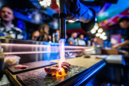 Close up of a piece of sushi under a flame