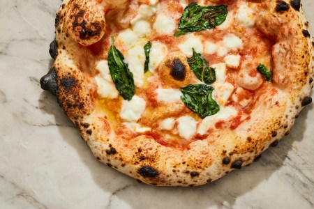 A Margherita pizza on a marble surface