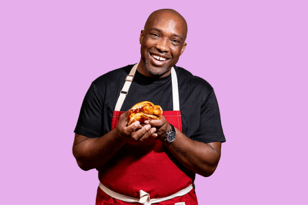 Chef Rahman "Rock" Harper holding Queen Mother's signature fried chicken sandwich